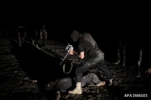 Palestinian militants of al-Nasser Salah al-Din Brigades, the armed wing of the Popular Resistance Committees (PRC), take part in a night military-style exercises at a training camp in Rafah in the southern Gaza Strip, A...