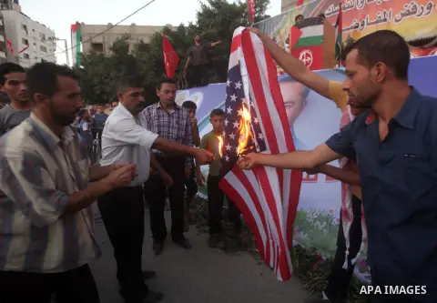 Palestinian supporters of Popular Front for the Liberation of Palestine (PFLP) burn a U.S. flag during a rally marking the 12th anniversary of the killing of Abu Ali Mustafa, leader of (PLFP), in Gaza City August 27, 201...