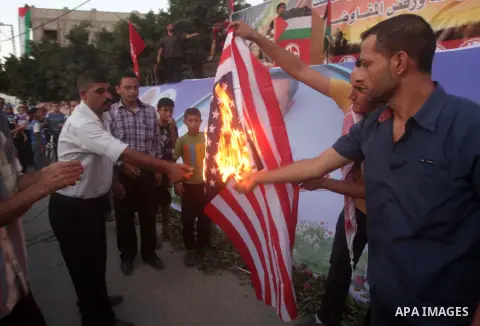 Palestinian supporters of Popular Front for the Liberation of Palestine (PFLP) burn a U.S. flag during a rally marking the 12th anniversary of the killing of Abu Ali Mustafa, leader of (PLFP), in Gaza City August 27, 201...