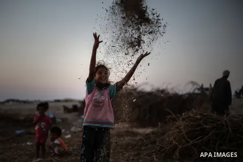 Palestinian children play outside their family's tent in a poverty-stricken quarter of the town of Khan Younis, in the southern Gaza Strip, 27 August 2013. Photo by Mahmoud Hamda
