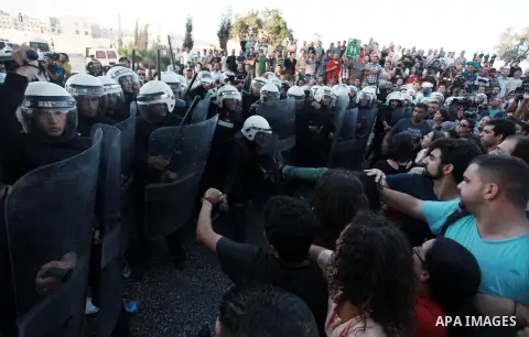 Palestinian riot police clash with protesters demonstrating against the Palestinian-Israeli negotiations as they try to march towards headquarters of Palestinian president Mahmud Abbas, in the West Bank city of Ramallah...