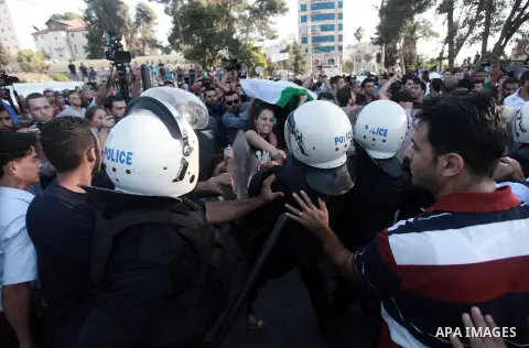 Palestinian riot police clash with protesters demonstrating against the Palestinian-Israeli negotiations as they try to march towards headquarters of Palestinian president Mahmud Abbas, in the West Bank city of Ramallah...