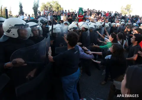 Palestinian riot police clash with protesters demonstrating against the Palestinian-Israeli negotiations as they try to march towards headquarters of Palestinian president Mahmud Abbas, in the West Bank city of Ramallah...