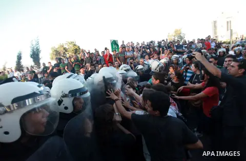 Palestinian riot police clash with protesters demonstrating against the Palestinian-Israeli negotiations as they try to march towards headquarters of Palestinian president Mahmud Abbas, in the West Bank city of Ramallah...