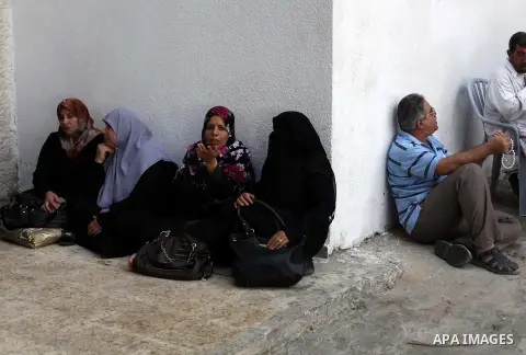 Palestinian families of martyrs and wounded take part a protest to demand their financial dues in Gaza City, on Aug. 29, 2013. Photo by Ashraf Amra