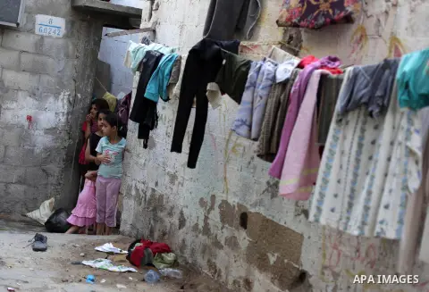 Palestinian children play outside their family homes at al-Shati refugee camp, in Gaza City on Aug 29, 2013. Photo by Ashraf Amra