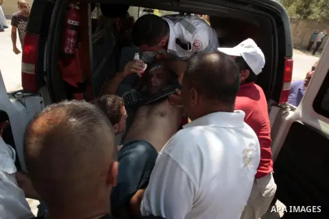 Palestinian protesters carry a wounded man during clashes with Israeli security forces following a protest against the expropriation of Palestinian land by Israel in the village of Kfar Qaddum, near Nablus in the occupie...