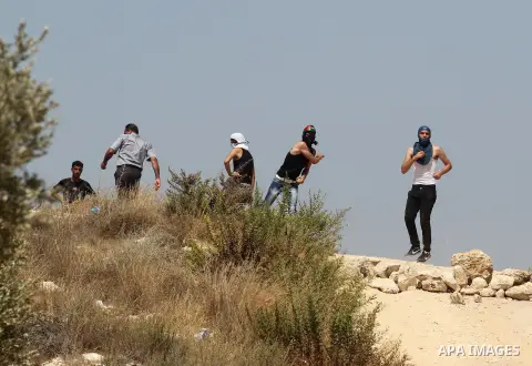 Palestinian protesters throw stones at Israeli border police during clashes after a protest against Israel's separation barrier and in solidarity with Palestinian prisoners being held in Israeli jails, in the West Bank v...