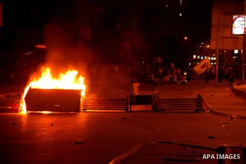 Supporters of Egypt's ousted President Mohammed Morsi, stand behind a burning sofa during a protest in Al-Mohandeseen in Cairo, Egypt, Friday, Aug. 30, 2013. Thousands of protesters and Muslim Brotherhood supporters rall...