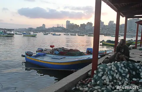 Palestinian fishermen pull their nets at the beach of Gaza city on Aug. 31, 2013. The Egyptian navy boats attacked the Palestinian boats off the southern Gaza Strip on Friday, near the border with Egypt, wounding fisherm...