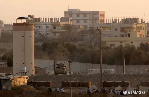 People look at the Gaza-Egypt border as Egyptian security forces explode smuggling tunnels dug beneath the border in the southern Gaza Strip August 31, 2013. Egyptian security forces have stepped up a crackdown campaign...