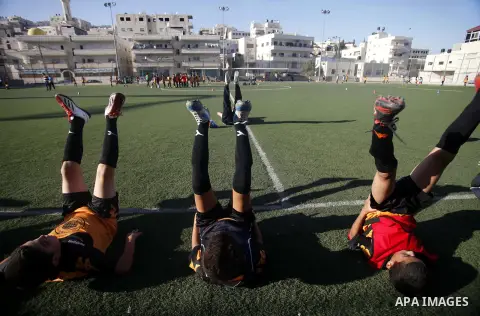 Palestinian boys play soccer during training exercises at a playground in Jerusalem, Aug. 31, 2013. About 200 Palestinian boy from the West Bank participated in the exercises to join the Palestinian Football Academy for...