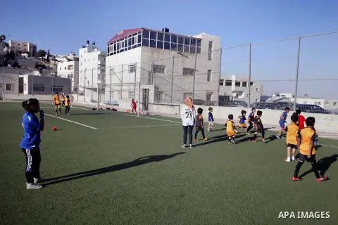 Palestinian boys play soccer during training exercises at a playground in Jerusalem, Aug. 31, 2013. About 200 Palestinian boy from the West Bank participated in the exercises to join the Palestinian Football Academy for...