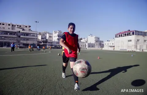 Palestinian boys play soccer during training exercises at a playground in Jerusalem, Aug. 31, 2013. About 200 Palestinian boy from the West Bank participated in the exercises to join the Palestinian Football Academy for...
