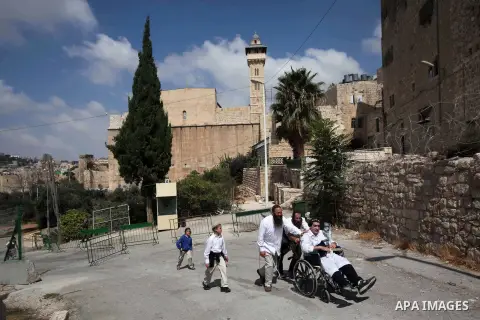 Ultra-Orthodox Jews walk outside the Ibrahimi mosque 'Tomb of the Patriarchs' in the West Bank City of Hebron on Sept. 05, 2013. Israeli authorities closed the roads leading to the Ibrahimi Mosque to Palestinian worshipe...