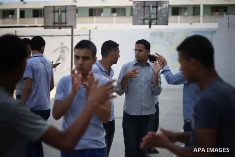 Deaf Palestinian students sign to each other at a special education school in Gaza City on Sept. 05, 2013. The school is the first in Gaza Strip that helps high school deaf students to join the University. Photo by Mahmo...