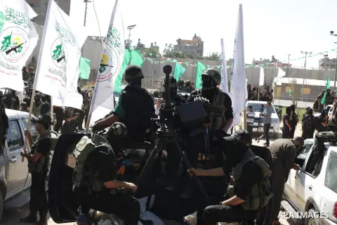 Palestinian militants take part in a protest against peace talks between Israel and the Palestinians, as well as possible U.S. attacks on Syria, in the northern Gaza Strip September 6, 2013. The protest was organized by...