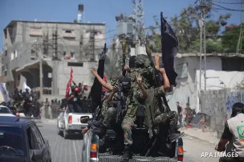 Palestinian militants take part in a protest against peace talks between Israel and the Palestinians, as well as possible U.S. attacks on Syria, in the northern Gaza Strip September 6, 2013. The protest was organized by...