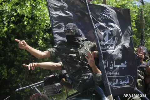 Palestinian militants take part in a protest against peace talks between Israel and the Palestinians, as well as possible U.S. attacks on Syria, in the northern Gaza Strip September 6, 2013. The protest was organized by...