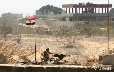 An Egyptian soldier stands guard on a military vehicle on the border between Egypt and southern Gaza Strip September 8, 2013. Egyptian security forces have destroyed at least 20 houses along the border with Gaza, local r...