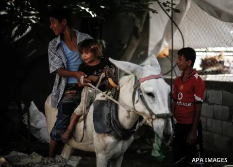Palestinian children play outside their home in the northern Gaza Strip refugee camp of Jabalia on Sept. 09, 2013. The United Nation says more than half of residents in the Gaza Strip are living under the poverty line. L...