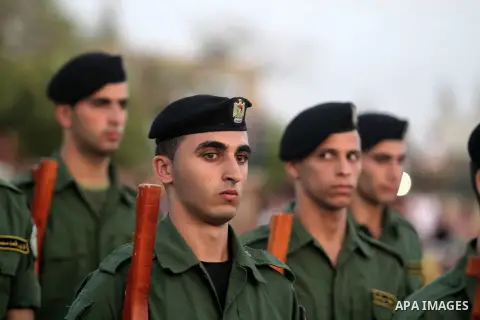 Male Palestinian students march during the graduation of students from the first batch of Bachelor degree from the college of security in the 'Independence' University in the West bank city of Jericho, 15 September 2013....