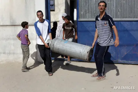 Palestinians wait to fill a cooking gas canister in station in Dir al-Balah in the central Gaza Strip September 17, 2013. The Gaza Strip is experiencing a shortage in cooking gas brought in from Israel, residents said. P...