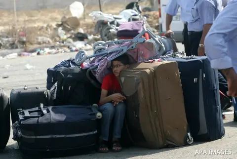 Palestinians wait to cross into Egypt at the Rafah crossing between Egypt and the southern Gaza Strip, on September 18, 2013. Egypt open its border crossing with the Gaza Strip after four days of closure, allowing travel...