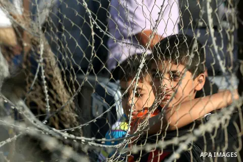 Palestinians wait to cross into Egypt at the Rafah crossing between Egypt and the southern Gaza Strip, on September 18, 2013. Egypt open its border crossing with the Gaza Strip after four days of closure, allowing travel...