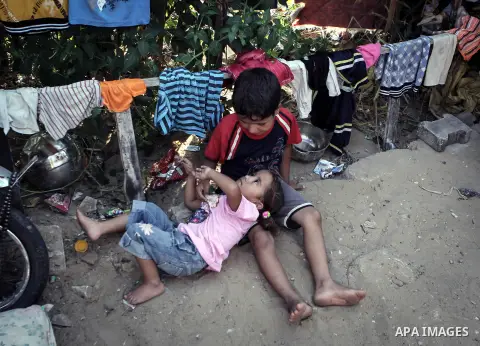 Palestinian children play outside their family's home in a poverty-stricken quarter of al-Zaytoon in Gaza City on Sept. 17, 2013. Reports said that an increasing number of Gaza families are reportedly falling further int...