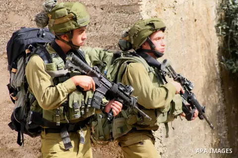 Israeli soldiers gather before starting a patrol in the West Bank city of Hebron, Monday, Sept. 23, 2013. Unknown gunmen shot and killed an Israeli soldier in the biblical city of Hebron in the West Bank on Sunday, and t...