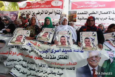 Families of Palestinian prisoners in the weekly sit-in to calling for the release of Palestinian prisoners from Israeli jails in front of the Red Cross in the West Bank City of Ramalla, on Sep. 24, 2013. Photo by Issam R...