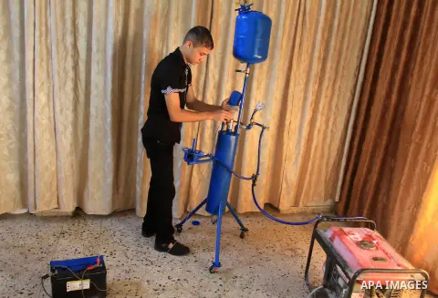 Palestinian student, Ibrahim Saad, 18, invents device "X_Zero Water Volt"، in Gaza City, on Sep. 25, 2013. The device produce hydrogen gas by analysing water, which uses to run an electricity generator and as cooking gas...