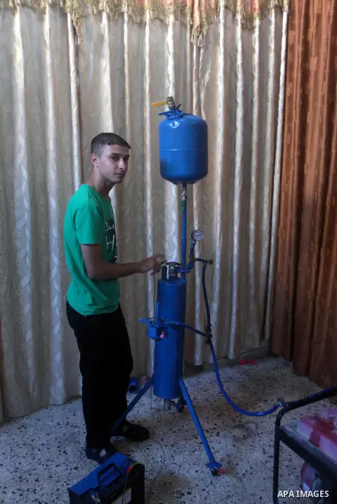 Palestinian student Ibrahim Saad, 18, tests his project at his home's workshop, in Gaza City on Sept. 26, 2013. The project aims to produce hydrogen gas by analysing water with chemicals, which uses to run an electricity...