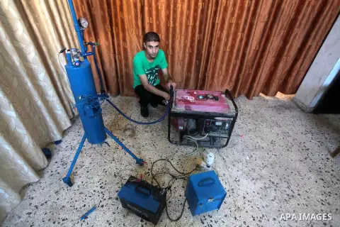 Palestinian student Ibrahim Saad, 18, tests his project at his home's workshop, in Gaza City on Sept. 26, 2013. The project aims to produce hydrogen gas by analysing water with chemicals, which uses to run an electricity...