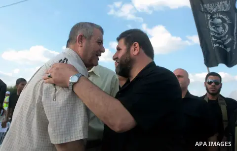 Secretary General of the Popular Resistance Movement Zakaria Doghmosh welcomes guests during a training session of Palestinian militants from Al Nasser Brigades, an armed wing of the Popular Resistance Committees (PRC),...