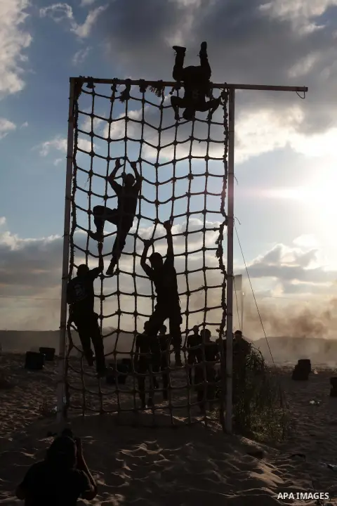 Palestinian militants from Al Nasser Brigades, an armed wing of the Popular Resistance Committees (PRC), take part in a training session in Khan Younis, southern Gaza Strip, Friday, Sept. 27, 2013. Photo by Ashraf Amra