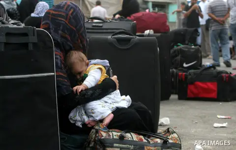 Palestinians wait at the Rafah border crossing in the southern Gaza Strip on September 28, 2013, for a brief opening allowing special cases to cross after Egyptian authorities closed the crossing "indefinitely" the day b...
