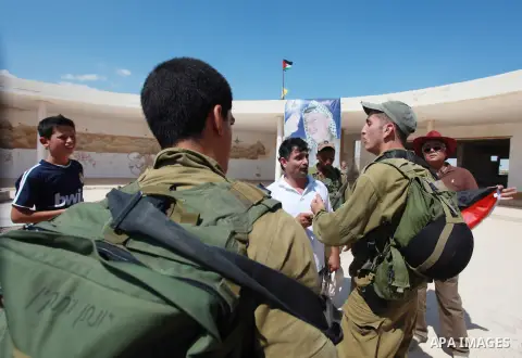 Israeli soldiers try to evacuate Palestinian and Israeli activists in the West Bank town of Jericho, on September 28, 2013, following a sit-in against the expropriation of Palestinian land by the Jewish state. Photo by I...