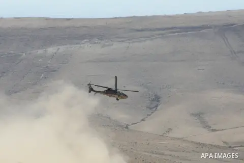 An Israeli military helicopter flies over the Massafer Yatta area, near the West Bank City of Hebron, on 01 October 2013. According to reports, Palestinian citizens in the area south of Yatta must leave while Israeli gov...