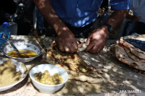 Palestinians make sandwiches of thyme during the activities of he 8th Annual Bilin Conference on the Palestinian Popular Struggle in Bilin, West Bank, 02 October 2013. The annual conference has become a platform for deba...