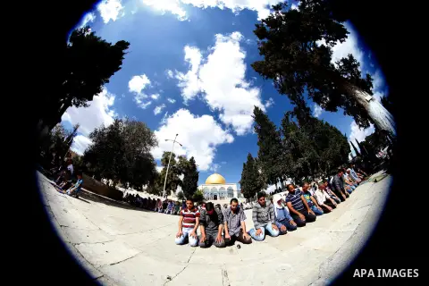 Palestinian worshipers pray outside the Dome of the Rock mosque at the Al-Aqsa compound, Islam s third holiest site, in the old city of Jerusalem, on October 4, 2013. Photo by Saeed Qaq