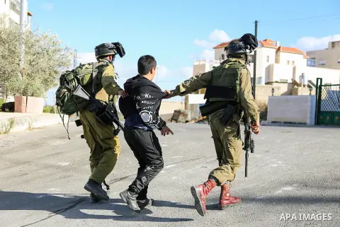 Israeli soldiers detain a Palestinian youth during clashes near the Israeli military prison of Ofer, near the West Bank city of Ramallah October 4, 2013. Photo by Issam Rimawi