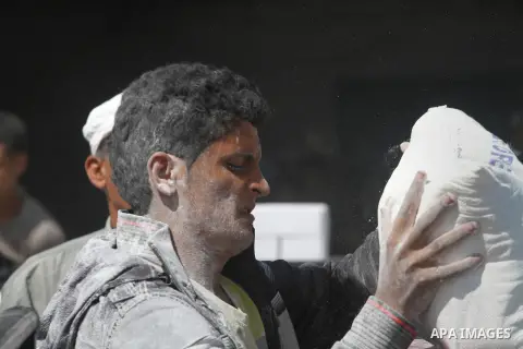 Palestinians receive humanitarian aid at the United Nations aid distribution centre in Gaza city on Oct. 06 ,2013. United Nations Relief and Works Agency (UNRWA) decide reduce its services in the Palestinian territories....