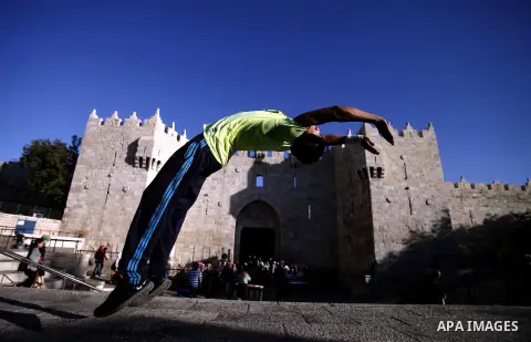 A Palestinian youth practices his parkour skills in front of Damascus gate in Jerusalem's Old City on October 08, 2013. Parkour, French slang for the art of moving, is a physical activity that maximizes the body's effici...