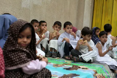 Palestinian children eat as part of training children how to perform Hajj pilgrimage, in Gaza City, on October 12, 2013. Muslims from around the world flood Saudi city of Mecca to perform the annual Hajj pilgrimage, whic...