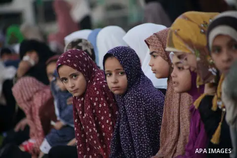 Palestinians attend the early morning Eid Al-adha prayer, at a football stadium in Gaza City, on Oct.15, 2013. Muslims around the world will celebrate Eid al-Adha or Feast of the Sacrifice by slaughtering sheep, goats, c...