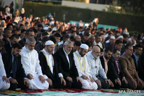 Palestinian Prime Minister in Gaza, Ismail Haniya, attends the early morning Eid Al-adha prayer, at a football stadium in Gaza City on Oct.15, 2013. Muslims around the world will celebrate Eid al-Adha or Feast of the Sac...