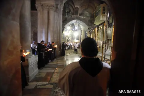 Christian worshipers pray at the church of the Holy Sepulchre in Jerusalem's Old City, 21 October 2013. The site is said to believed to be the place where Jesus was buried. Photo by Saeed Qaq