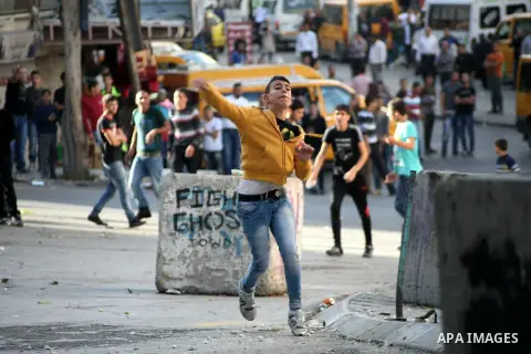 Palestinian youths clash with Israeli forces in the West Bank city of Hebron, after killing of Palestinian Islamic Jihad militant Mohamed Assi in Bilin near Ramallah, Tuesday, Oct. 22, 2013. Israel's security service and...